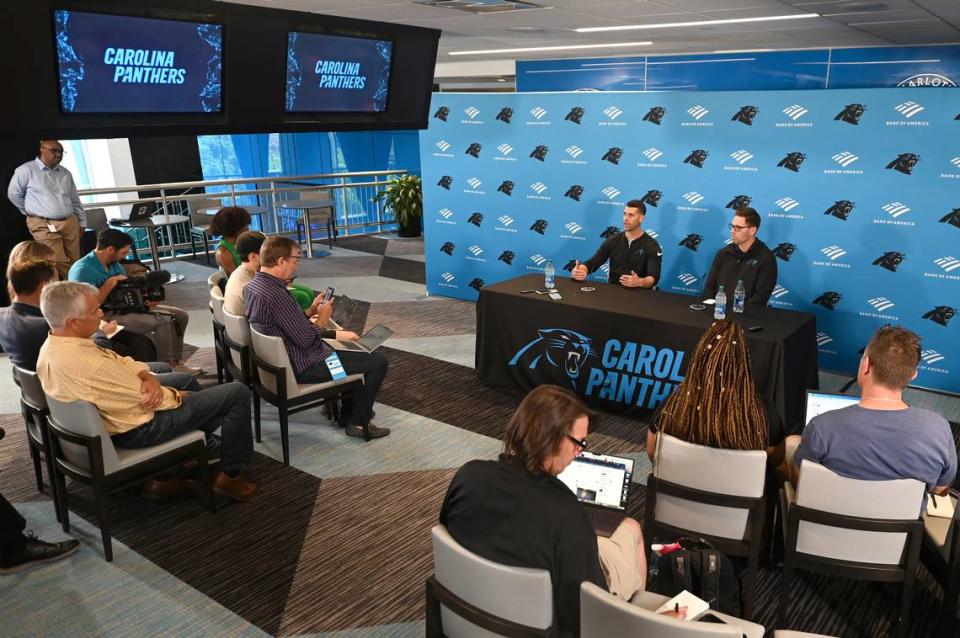 Carolina Panthers head coach Dave Canales, left, answers a question as general manager Dan Morgan, right, listens during a pre-draft press conference at Bank of America Stadium on Thursday, April 18, 2024.
