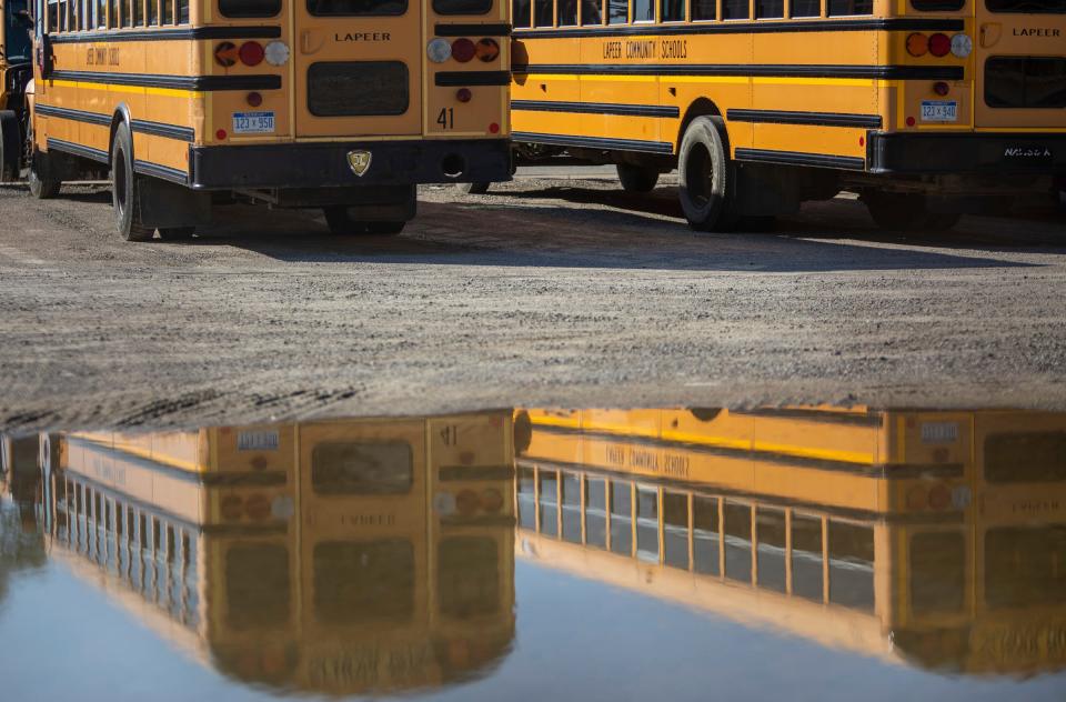 Two school buses sit beside one another inside the Lapeer Schools Transportation bus garage on Tuesday, Oct. 3, 2023. Charlie Fox was lost on a Lapeer Schools' bus at 5 years old in 2019. Fox was found at the bus garage, sitting inside one of the buses, waiting. "Charlie was on the bus for just over 2 hours total," her mother Sarah said. "I can't remember when she was loaded up, but she was on the entire bus route for almost an hour and wasn't found until 5:07 pm."
