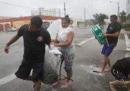 <p><strong>Miami</strong><br>People take time to clear debris out of a drainage ditch to keep the area from flooding as Hurricane Irma passes through on Sept. 10, 2017 in Miami, Fla. (Photo: Joe Raedle/Getty Images) </p>