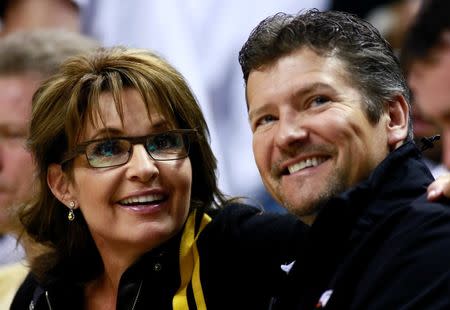 Former U.S. Republican vice-presidential candidate Sarah Palin and her husband Todd watch the NBA Eastern Conference final basketball playoff series between the Miami Heat and the Indiana Pacers in Indianapolis, Indiana, in this file photo taken May 26, 2013. REUTERS/Brent Smith/Files