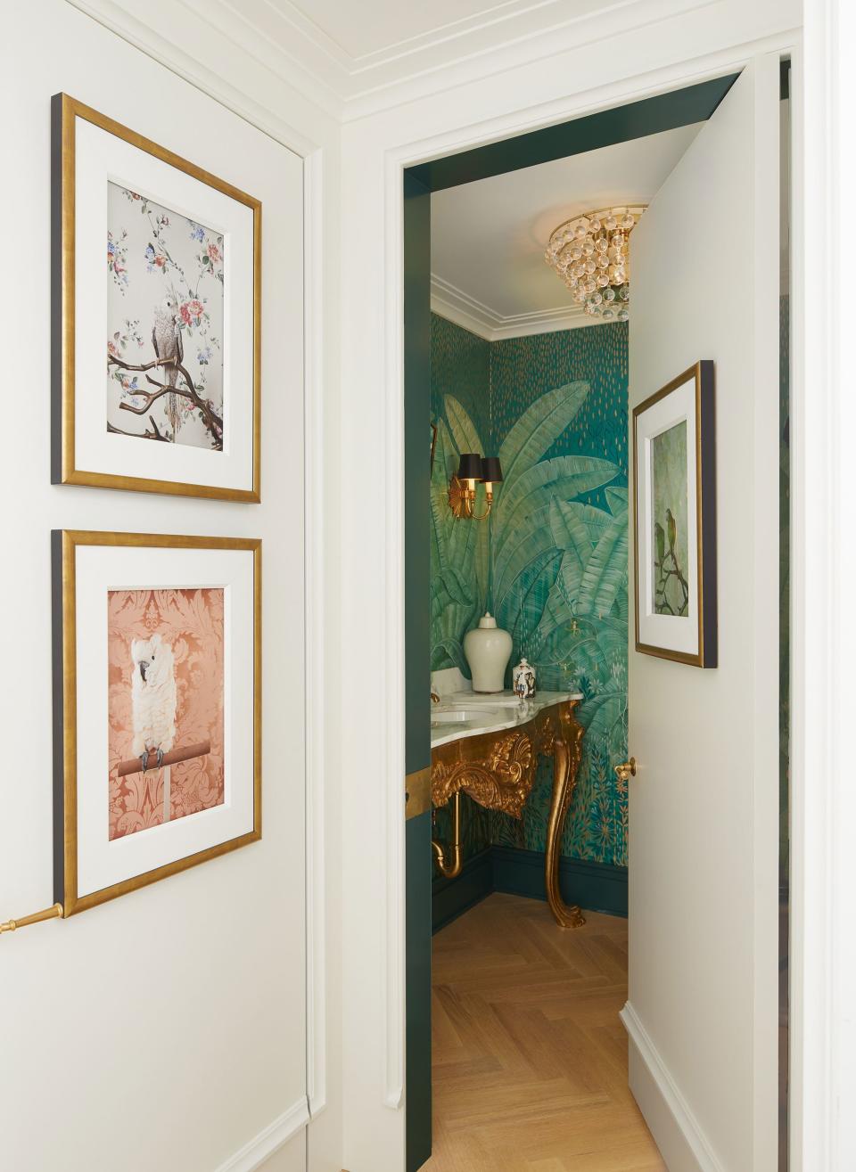 A collection of photographs by Claire Rosen from her “Birds of a Feather” series lines the gallery. In the powder room, the hand-painted wallpaper is by decorative artist Colette Cosentino.