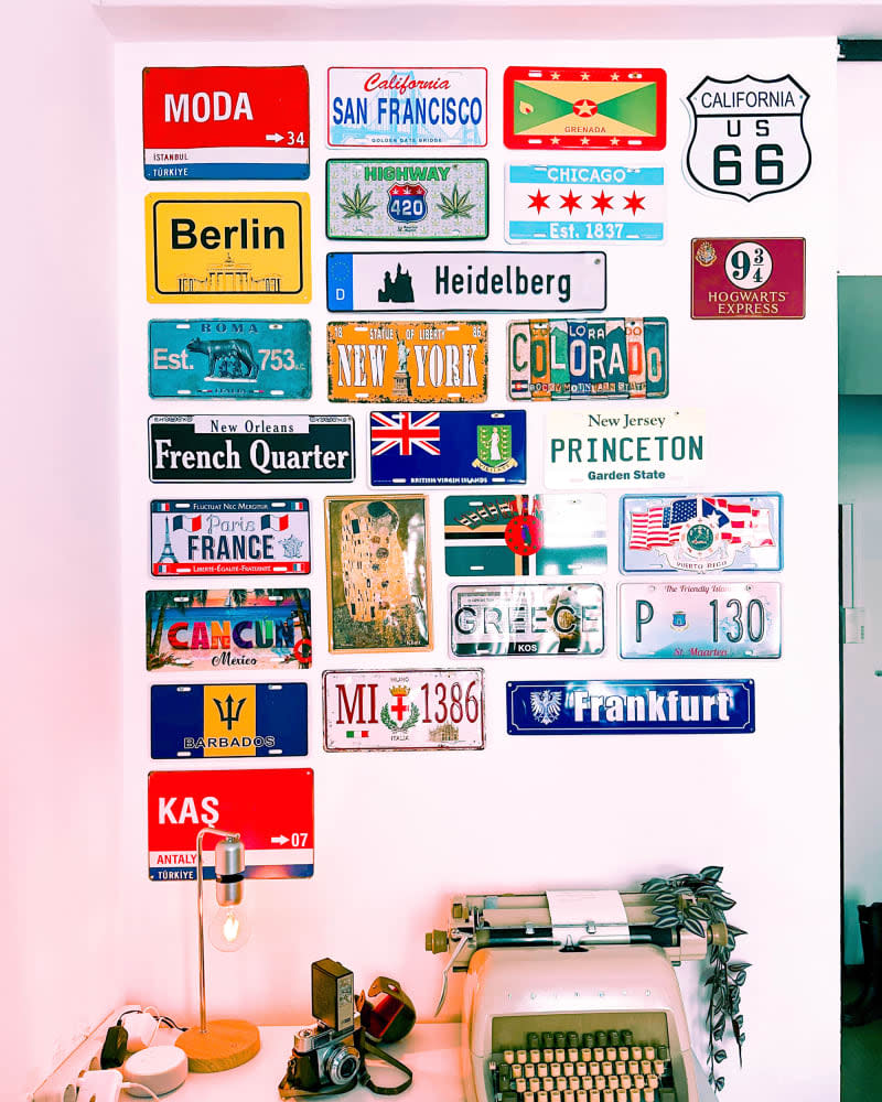 Various license plates mounted on dorm wall.