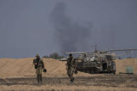 Israeli soldiers from the artillery unit deployed at the Israeli Gaza border, Saturday, Aug. 6, 2022. Israeli jets pounded militant targets in Gaza as rockets rained on southern Israel, hours after a wave of Israeli airstrikes on the coastal enclave killed at least 11 people, including a senior militant and a 5-year-old girl. The fighting began with Israel's dramatic targeted killing of a senior commander of the Palestinian Islamic Jihad continued into the morning Saturday, drawing the sides closer to an all-out war. (AP Photo/Ariel Schalit)