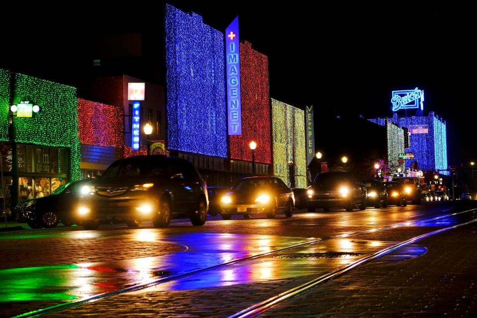 The buildings along Broadway Avenue are draped with colorful lights for Automobile Alley's Lights on Broadway Tuesday, November 24, 2020.