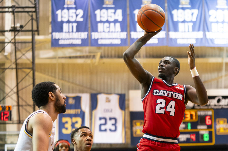 Dayton's Kobe Elvis, right, shoots with La Salle's Daeshon Shepherd, left, defending during the first half of an NCAA college basketball game Tuesday, Jan. 23, 2024, in Philadelphia. (AP Photo/Chris Szagola)