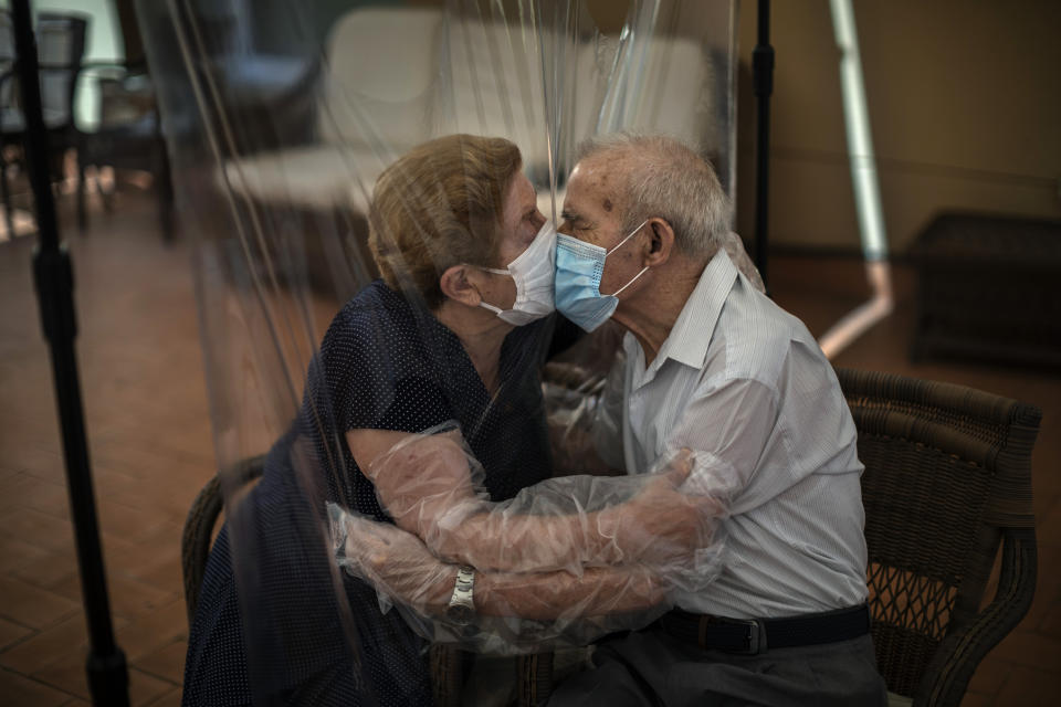 Agustina Canamero, 81, and Pascual Pérez, 84, hug and kiss through a plastic film screen to avoid contracting the new coronavirus at a nursing home in Barcelona, Spain, June 22, 2020. Associated Press photographer Emilio Morenatti says this of the image: “I couldn’t help feeling emotional myself while I was shooting, and I realized that such an eternal moment symbolized something more than a simple meeting. The plastic kept the virus but not the love away.” (AP Photo/Emilio Morenatti)