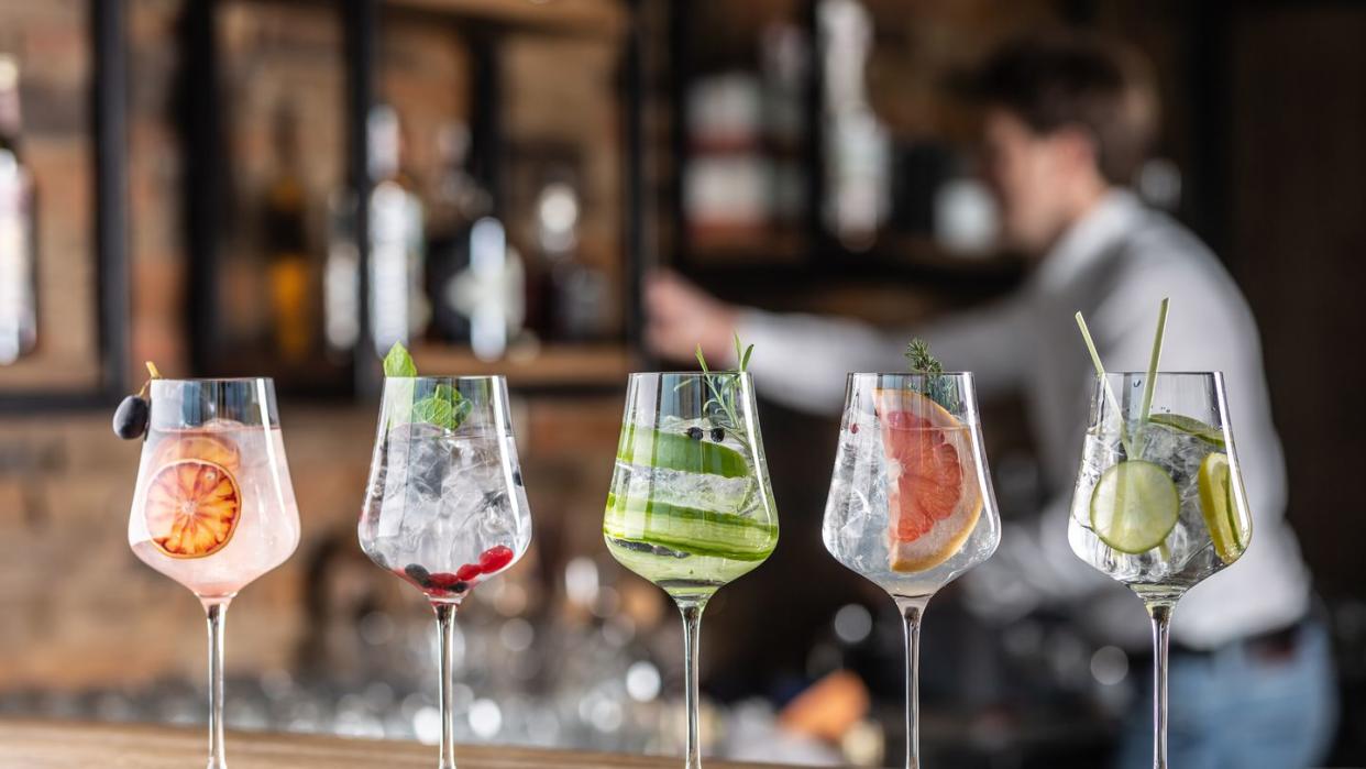 selection of various cocktails in wine glasses in a bar