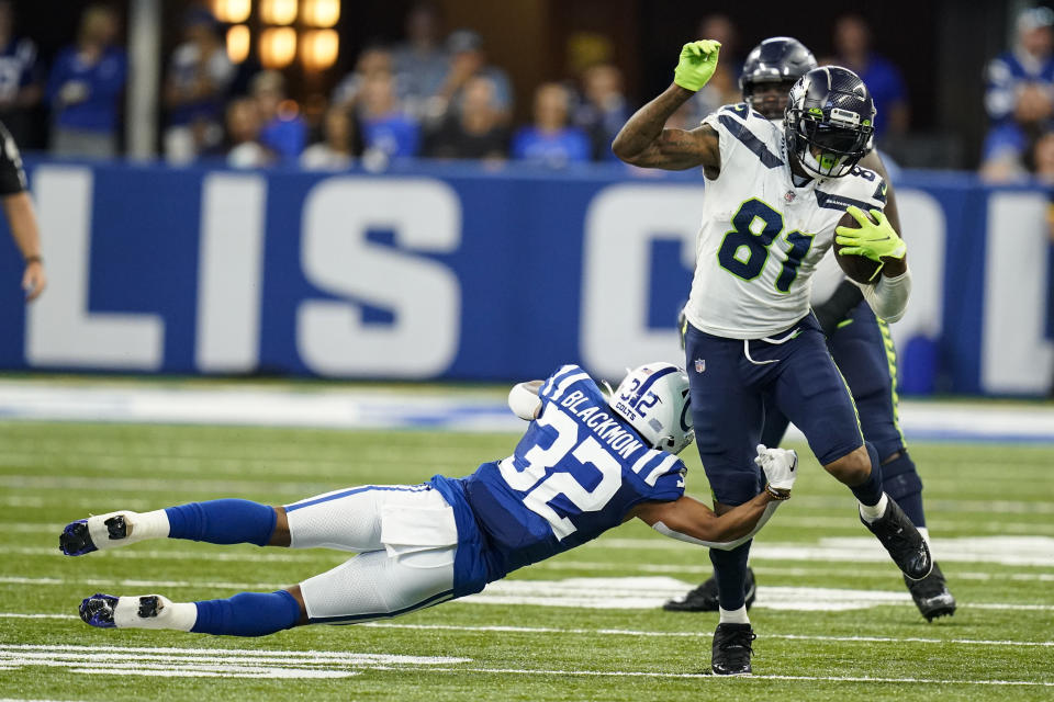 Indianapolis Colts safety Julian Blackmon (32) tackles Seattle Seahawks tight end Gerald Everett (81) in the first half of an NFL football game in Indianapolis, Sunday, Sept. 12, 2021. (AP Photo/Charlie Neibergall)