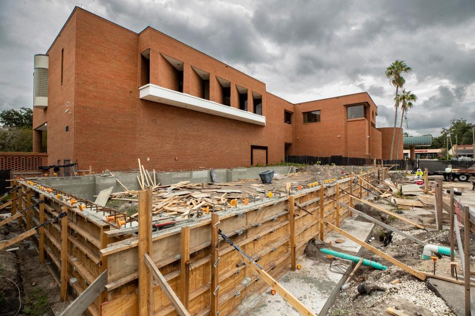 Construction proceeds on the new wing of the Polk Museum of Art, as the original building stands in the background. The expansion is expected to be complete by fall 2024.