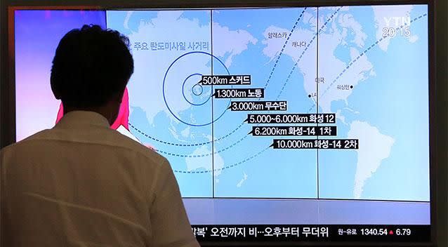 A man watches a TV screen showing a local news program reporting on North Korea's missiles, at the Seoul Railway Station in Seoul. Photo: AAP