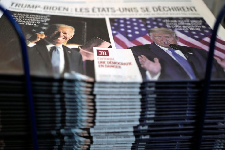 A pile of the French newspaper Le Monde headlines is seen at a newspaper stand in Paris, on Nov. 4, 2020.