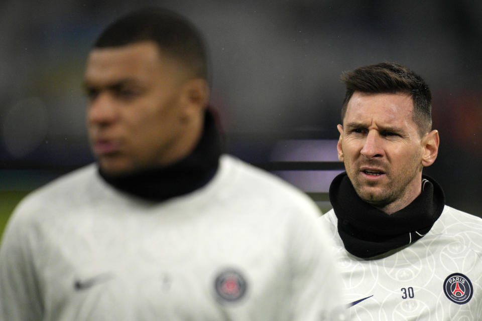 PSG's Lionel Messi, right and PSG's Kylian Mbappe walk during warm up before the French League One soccer match between Marseille and Paris Saint-Germain at the Velodrome stadium in Marseille, southern France, Sunday, Feb. 26, 2023. (AP Photo/Daniel Cole)