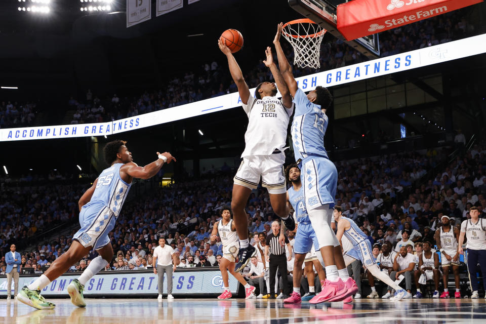 Georgia Tech forward Tyzhaun Claude, left, scores over North Carolina forward Jalen Washington, right, during the second half of an NCAA college basketball game Tuesday, Jan. 30, 2024, in Atlanta. (AP Photo/Alex Slitz)