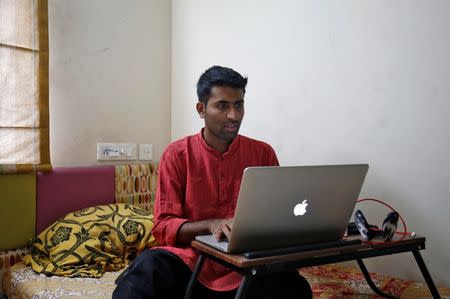 Akhilesh Godi, one of the petitioners challenging India's ban on homosexuality, checks his laptop as he poses inside his house in Bengaluru, India, July 18, 2018. REUTERS/Abhishek N. Chinnappa