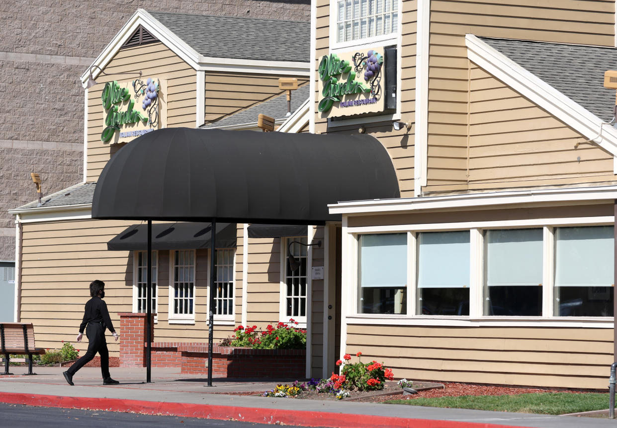 FREMONT, CALIFORNIA - MARCH 24: A worker enters an Olive Garden restaurant on March 24, 2022 in Fremont, California. Olive Garden parent restaurant Darden Restaurants reported third quarter earnings that fell short of analyst expectations with revenue of $2.45 billion compared to an expected $2.51 billion.  (Photo by Justin Sullivan/Getty Images)