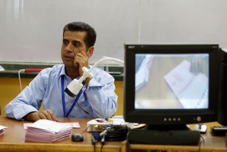 Officials count ballots by the camera after polls close at a polling station for parliamentary elections in Amman, Jordan, September 20, 2016. REUTERS/Muhammad Hamed