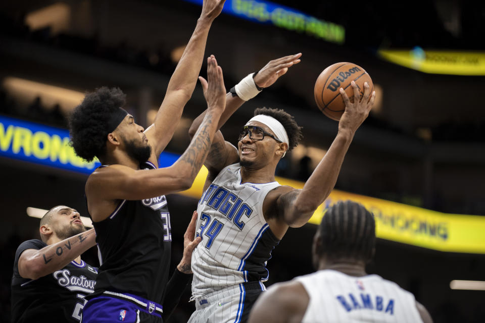 Orlando Magic center Wendell Carter Jr. (34) is defended by Sacramento Kings forward Marvin Bagley III (35) during the second half of an NBA basketball game in Sacramento, Calif., Wednesday, Dec. 8, 2021. (AP Photo/Jose Luis villegas)