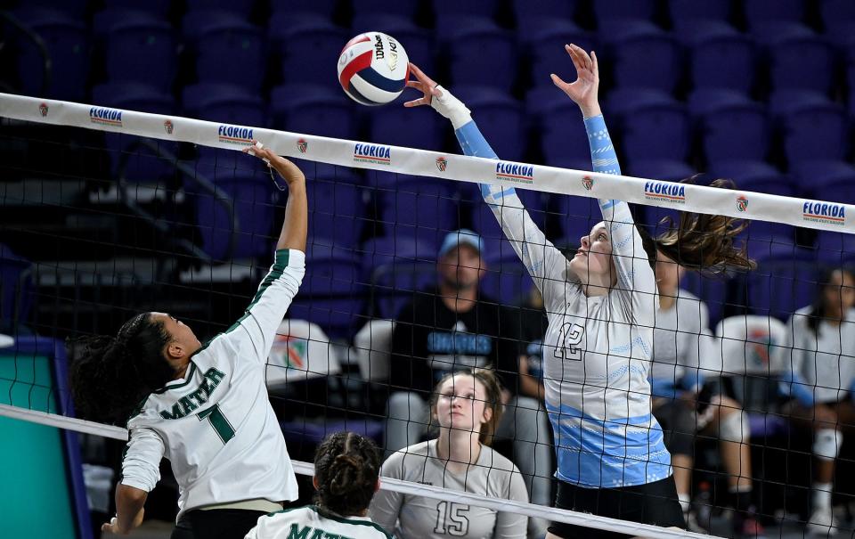 Ponte Vedra's Chelsea Sutton (12) challenges for a ball at the net during last year's Class 6A state championship match. Sutton, who recently signed to play college volleyball at Tennessee, is one of the Sharks' four commits.