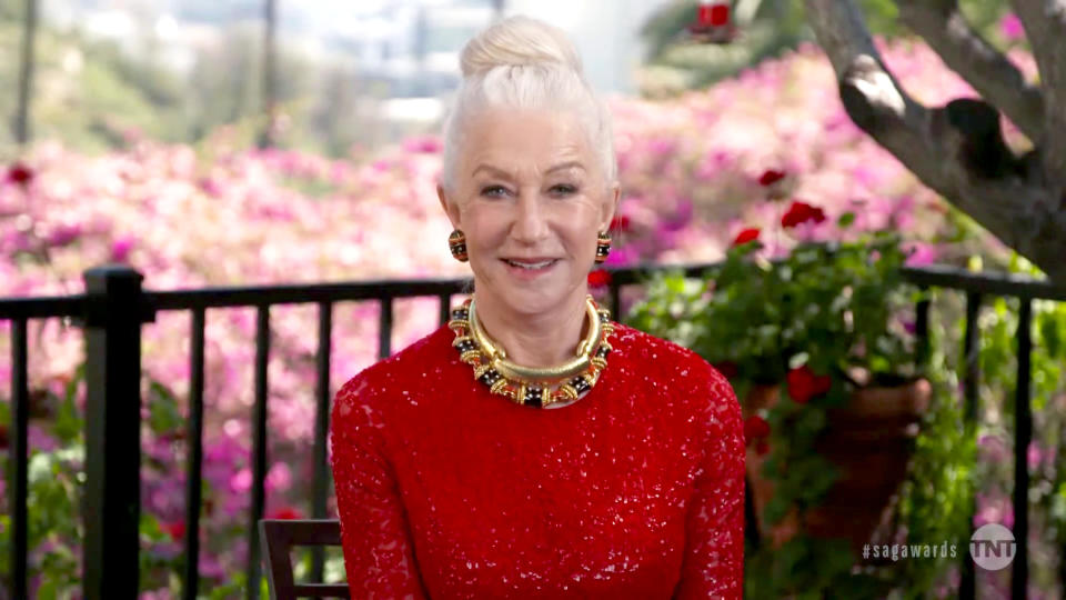 Helen is sitting in a sparkly red gown