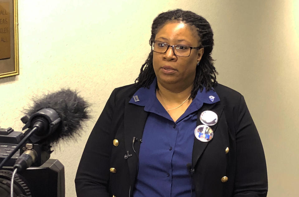 Allison Carraway, the widow of a police officer killed in the line of duty, speaks to reporters about her support of a bill that would require state police investigate all officer-involved shootings in South Carolina after a state Senate hearing on Tuesday, Jan. 15, 2019, in Columbia, S.C. Carraway said she is frustrated by a lack of answers and support after her husband's death. (AP Photo/Jeffrey Collins)