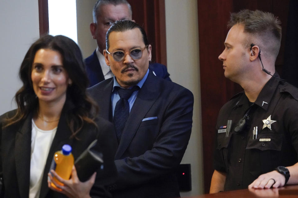 Actor Johnny Depp arrives in the courtroom for closing arguments at the Fairfax County Circuit Courthouse in Fairfax, Va., Friday, May 27, 2022. Depp sued his ex-wife Amber Heard for libel in Fairfax County Circuit Court after she wrote an op-ed piece in The Washington Post in 2018 referring to herself as a "public figure representing domestic abuse." (AP Photo/Steve Helber, Pool)