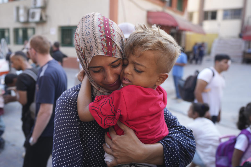 A Palestinian woman says goodbye to her sick son before leaving the Gaza Strip to get treatment abroad through the Kerem Shalom crossing, in Khan Younis, southern Gaza Strip, Thursday, June 27, 2024. 21 patients in the Gaza Strip evacuated the war-torn enclave in an initiative led by the World Health Organization for the children to receive life-saving treatment elsewhere. (AP Photo/Abdel Kareem Hana)