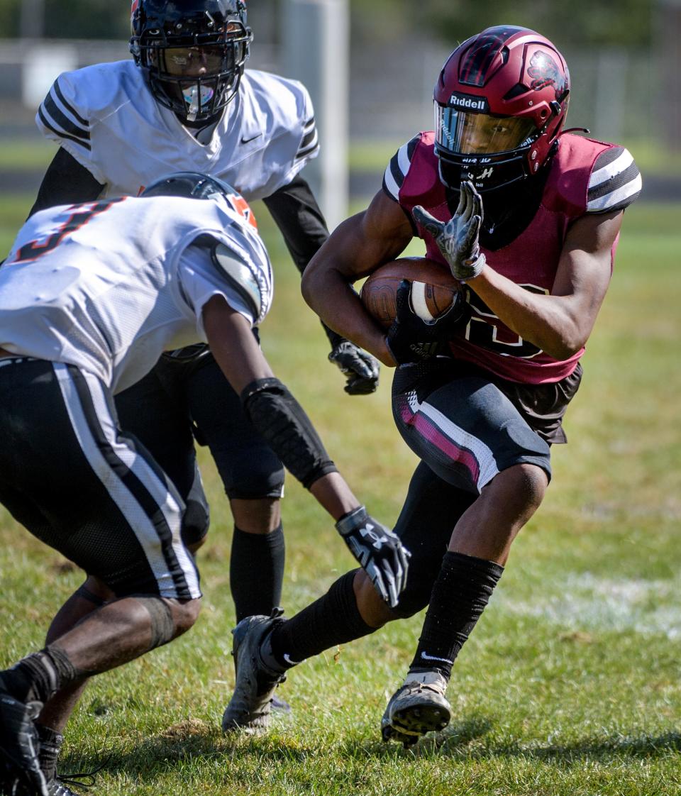 Peoria's Gary Rutherford tries to get past a pair of Manual defenders in the second half Saturday, Sept. 24, 2022 at Peoria Stadium.