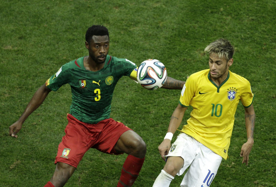 Brazil&#39;s Neymar fights for the ball with Cameroon&#39;s Nicolas N’Koulou during the group A World Cup soccer match between Cameroon and Brazil at the Estadio Nacional in Brasilia, Brazil, Monday, June 23, 2014. (AP Photo/Christophe Ena)