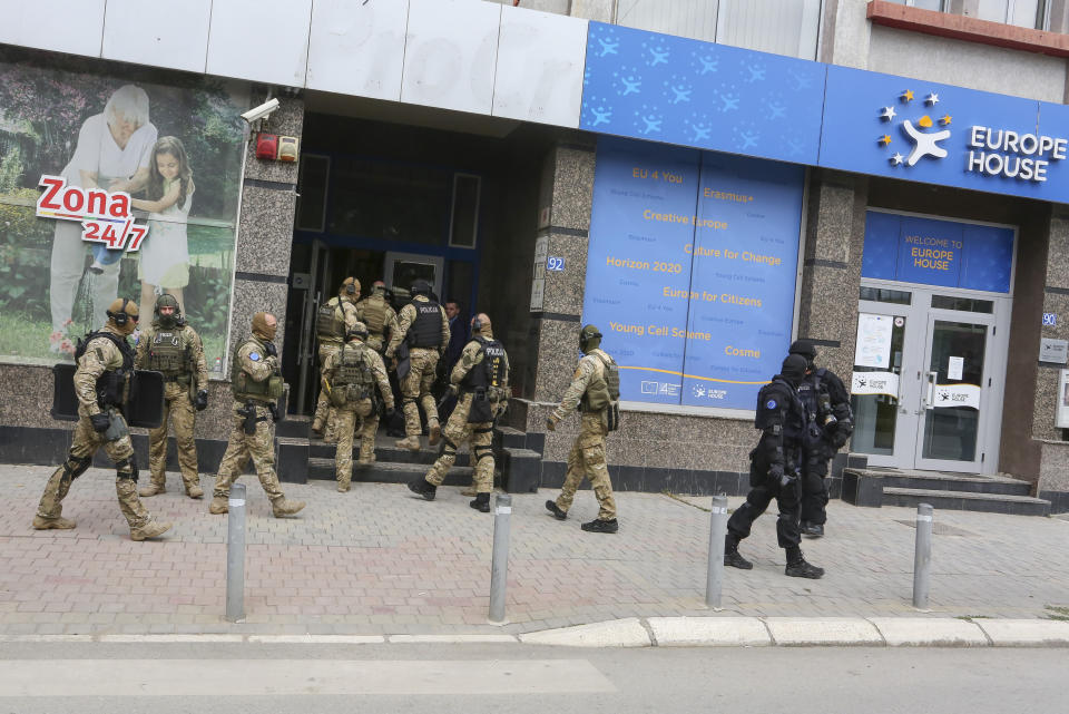 European Union security police enter the offices of a war veterans association in Kosovo, in Pristina, Friday, Sept. 25, 2020. Witnesses say European Union security police have stormed the offices of a war veterans association in Kosovo. The association represents the former ethnic Albanian separatists who fought Serbian troops in a 1998-1999 war for independence. Members of the group said police from the European Union Rule of Law Mission in Kosovo, or EULEX, prevented them from going into the association’s offices in Pristina on Friday. (AP Photo/Visar Kryeziu)