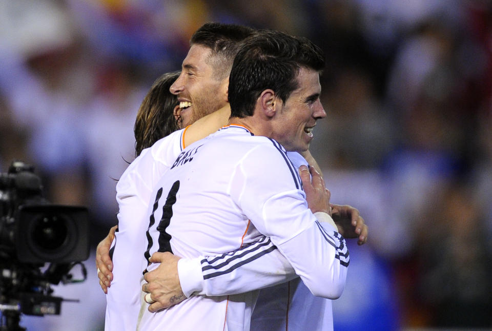 Real's Gareth Bale, right, celebrates with Sergio Ramos at the end of the final of the Copa del Rey between FC Barcelona and Real Madrid at the Mestalla stadium in Valencia, Spain, Wednesday, April 16, 2014. Real defeated Barcelona 2-1. (AP Photo/Manu Fernandez)