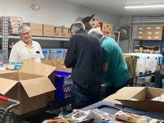 Fish Inc. volunteers prepare monthly food bags to be delivered to the senior housing in Middlesex.