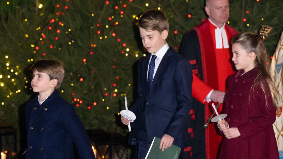 George, Charlotte and Louis holding candles at carol service