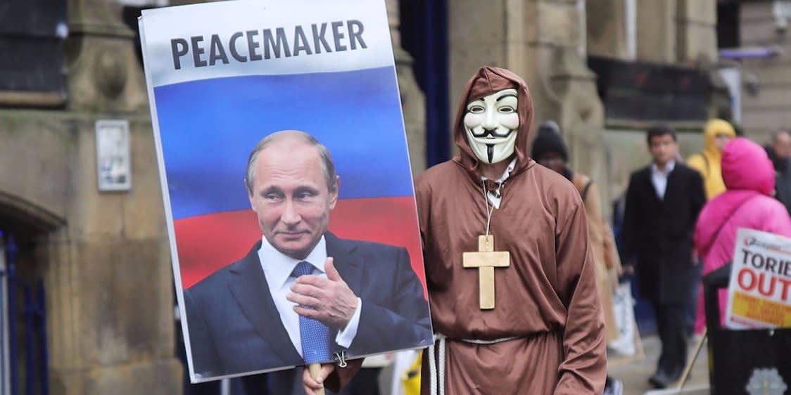 A man dressed up in a mask and holding a sign with Vladimir Putin on it saying 'Peacemaker' takes part in anti-Brexit and anti-austerity protests as the Conservative party annual conference gets underway at Manchester Central on October 1, 2017 in Manchester, England. Five-hundred thousand people are expected to take part in the protests with police mounting an unprecedented security operation of a thousand officers and extra armed police to protect Conservative party conference delegates. (Photo by Christopher Furlong/Getty Images)