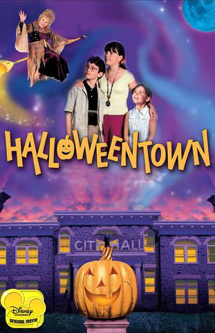 <p>Cinematic / Alamy</p> Debbie Reynolds, Joey Zimmerman, Kimberly J. Brown and Emily Roeske on the 1998 'Halloweentown' poster