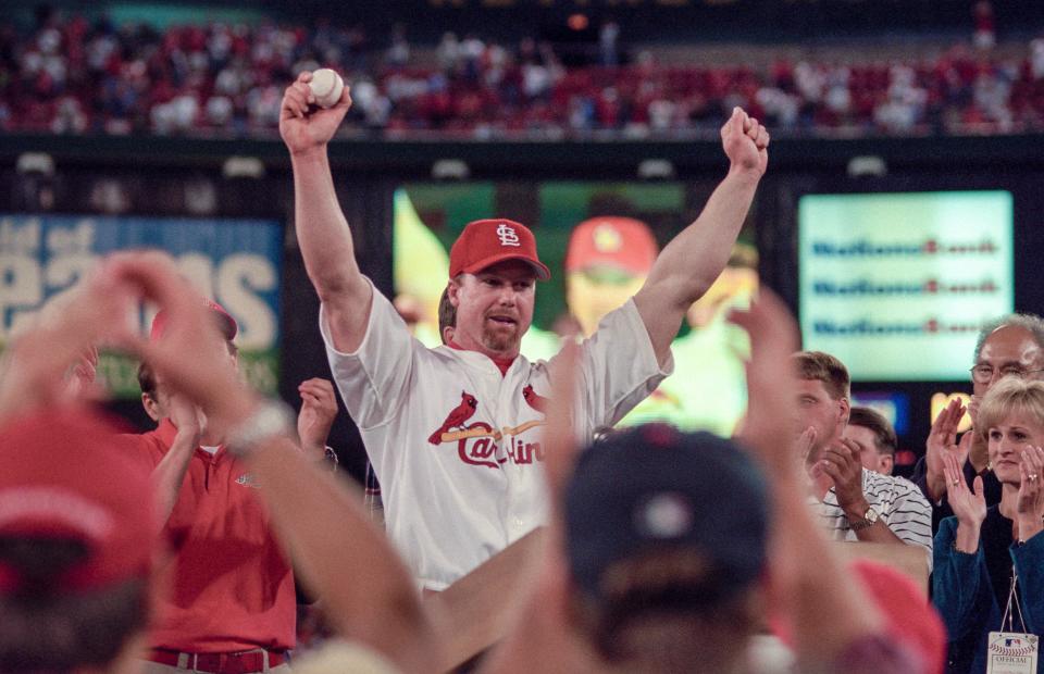 Mark McGwire celebrates at Busch Stadium after the game on Sept. 8.