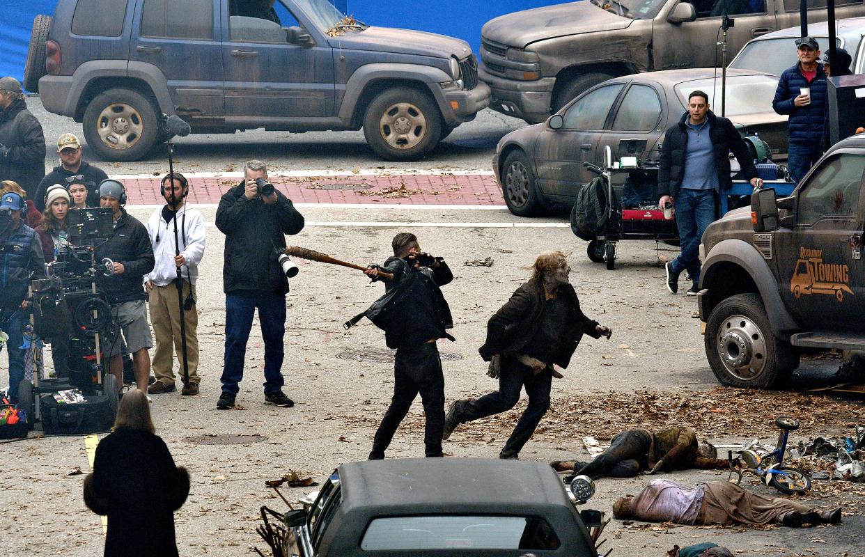 Negan, played by Jeffrey Dean Morgan bats a walker with Lucille, his barbed-wire covered baseball bat, while filming for "The Walking Dead: Dead City" on Norwich Street Monday.