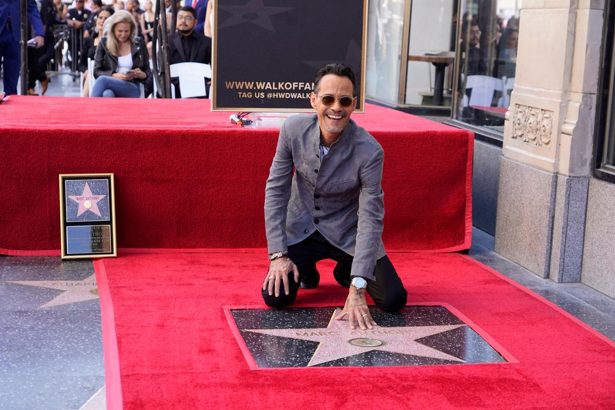 Marc Anthony touches his star during a ceremony honoring him with a star on the Hollywood Walk of Fame on Sept. 7, 2023, in Los Angeles.