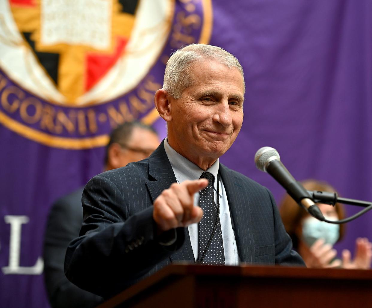 Dr. Anthony Fauci points to a crowd of College of the Holy Cross students, faculty and alumni during a rededication of its science complex in his honor in June.