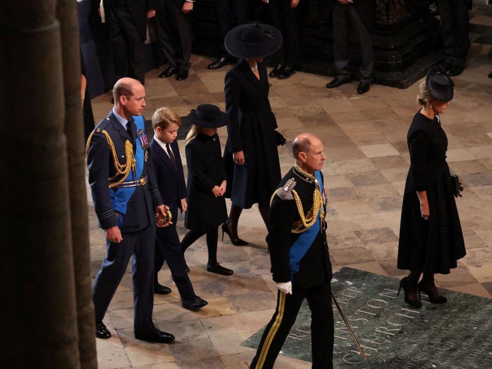 Prince George and Princess Charlotte walk in between Prince William and Kate Middleton at Westminster Abbey.