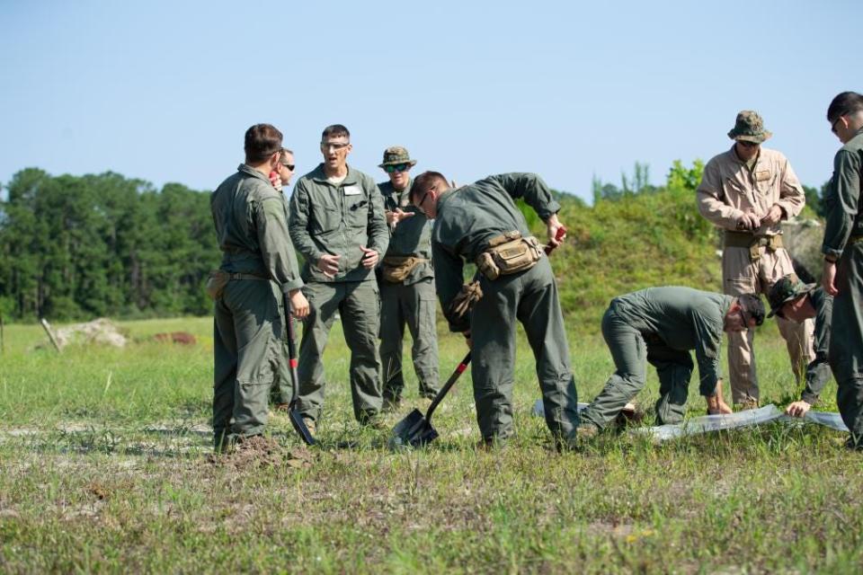 Marine Corps Chief Warrant Officer 5 Michael Gaydeski, the officer in charge for Headquarters and Headquarters Squadron Explosive Ordnance Disposal (EOD), goes over standard operating procedures with EOD technicians during a practice event at Marine Corps Air Station (MCAS) Cherry Point, North Carolina, Aug. 12, 2021.