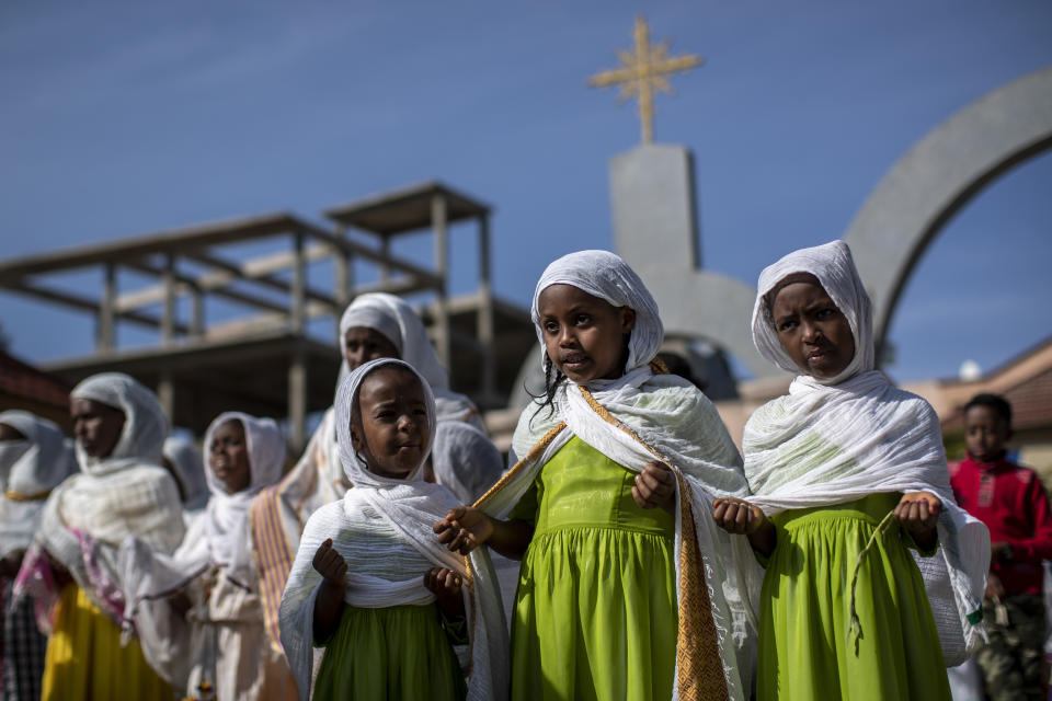 Children and other congregants pray during a Sunday morning service of the Ethiopian Orthodox Tewahedo Church at the Church of St. Mary in Mekele, in the Tigray region of northern Ethiopia Sunday, May 9, 2021. The head of the Ethiopian Orthodox Church, Patriarch Abune Mathias, in a video shot last month on a mobile phone and carried out of Ethiopia, sharply criticized Ethiopia's actions in the conflict in the country's Tigray region. Some thousands of Eritrean refugees are among the most vulnerable groups in the conflict and are increasingly caught in the middle of the conflict in Ethiopia’s Tigray region. (AP Photo/Ben Curtis, FILE)