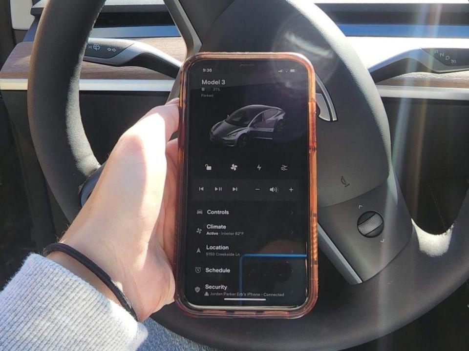 The Tesla app is shown on an iPhone.