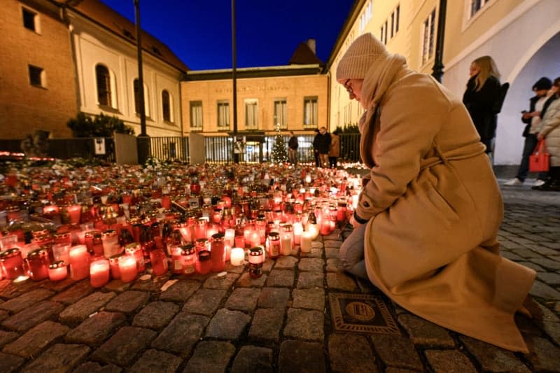 People place candles at the memorial site for the victims of the shooting at the Faculty of Arts of Charles University. Šimánek Vít/CTK/dpa