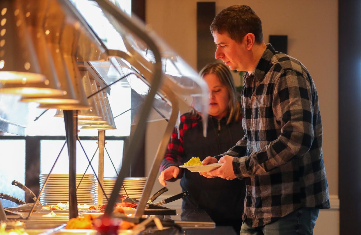 Matt Beaudo goes through the buffet line during brunch service on Sunday, March 10, 2024, at River's Bend in Howard, Wis.
Tork Mason/USA TODAY NETWORK-Wisconsin