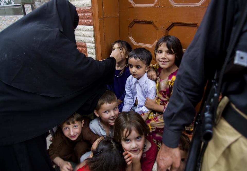 Pakistani children wait their turns to receive polio vaccines in Rawalpindi, Pakistan, Tuesday, May 6, 2014. Pakistan’s health minister says the country is taking extra ordinary measures to meet the new situation it is going to face after polio travel restrictions. (AP Photo/B.K. Bangash)