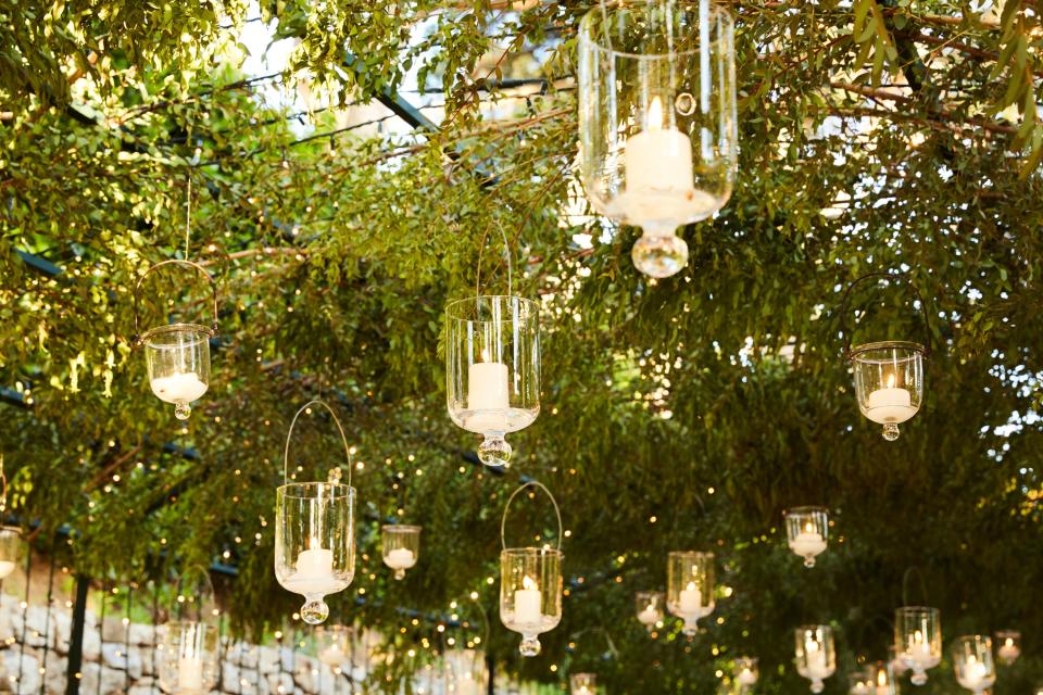 Everyone was seated one long table under a canopy of greenery strung with lights and hanging candles.