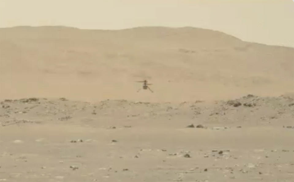 In this image from video made available by NASA, the Mars Ingenuity helicopter hovers above the surface of the planet during its second flight on Thursday, April 22, 2021. (NASA via AP)