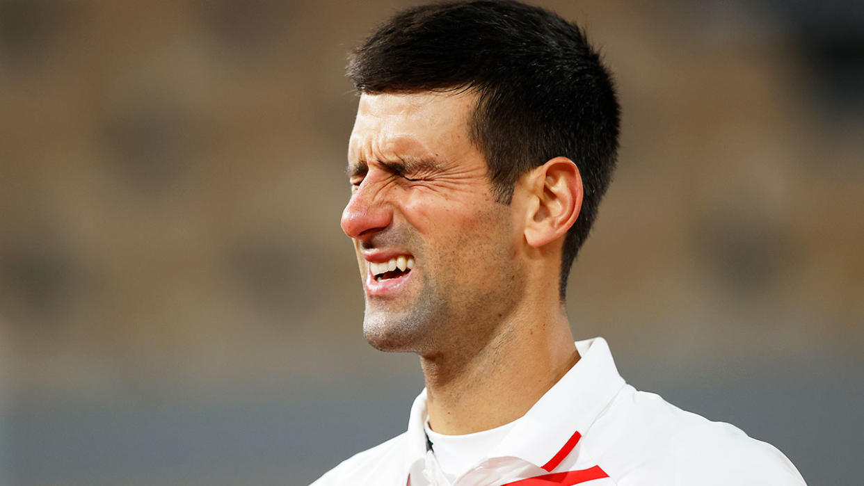 Pictured here, Novak Djokovic grimaces in pain during his French Open quarter-final.