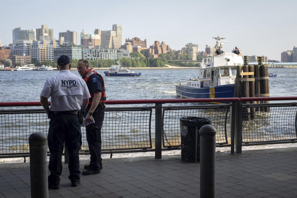 Authorities investigate the death of a baby boy who was found floating in the water near the Brooklyn Bridge in Manhattan, on Sunday, Aug. 5, 2018, in New York. No parent or guardian was present at the scene and the child showed no signs of trauma, police said. The medical examiner will determine the exact cause of death. (AP Photo/Robert Bumsted)