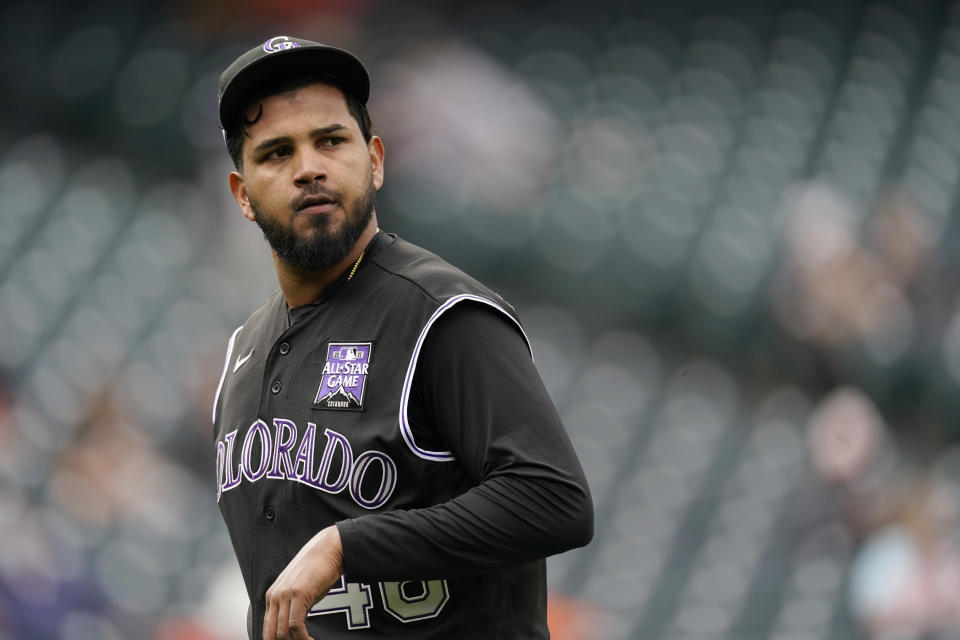 Colorado Rockies starting pitcher German Marquez checks the scoreboard as he heads to the dugout after being pulled form the mound following his walk to San Francisco Giants' Mike Tauchman in the first inning of game one of a baseball doubleheader Tuesday, May 4, 2021, in Denver. (AP Photo/David Zalubowski)